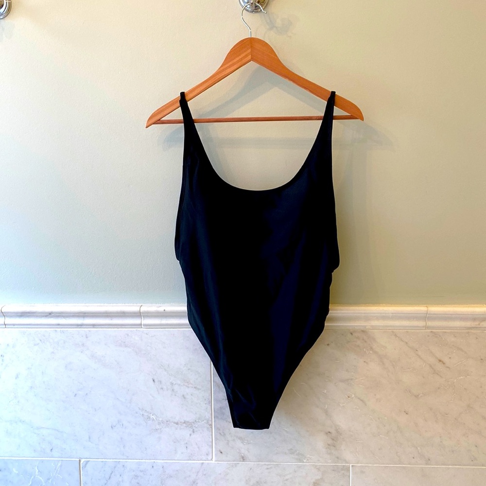 Black one piece open back swimsuit with gold detail
